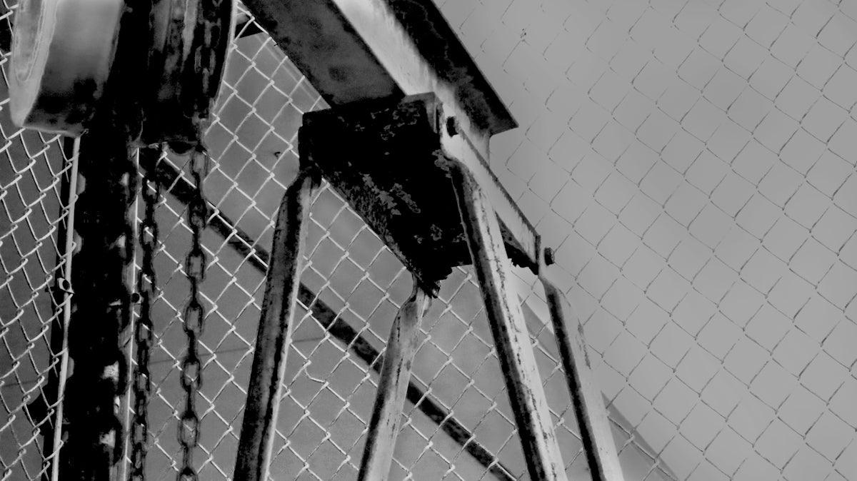 a black and white photo of a chain link fence