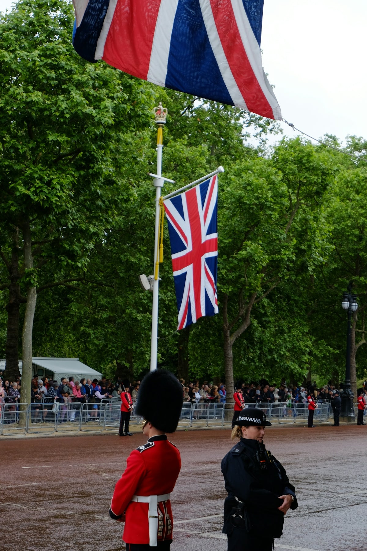 A man in a uniform standing in front of a flag