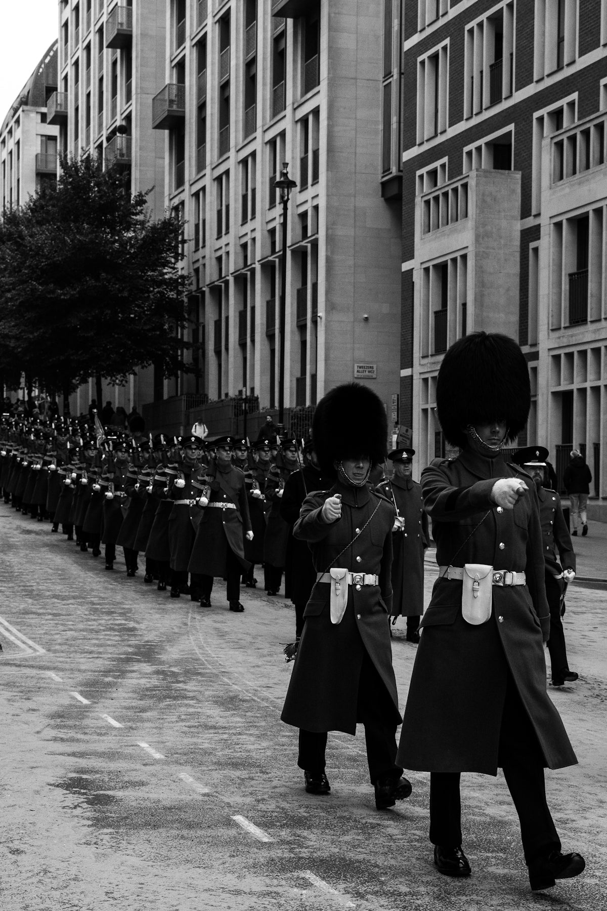 A group of men in uniform marching down a street
