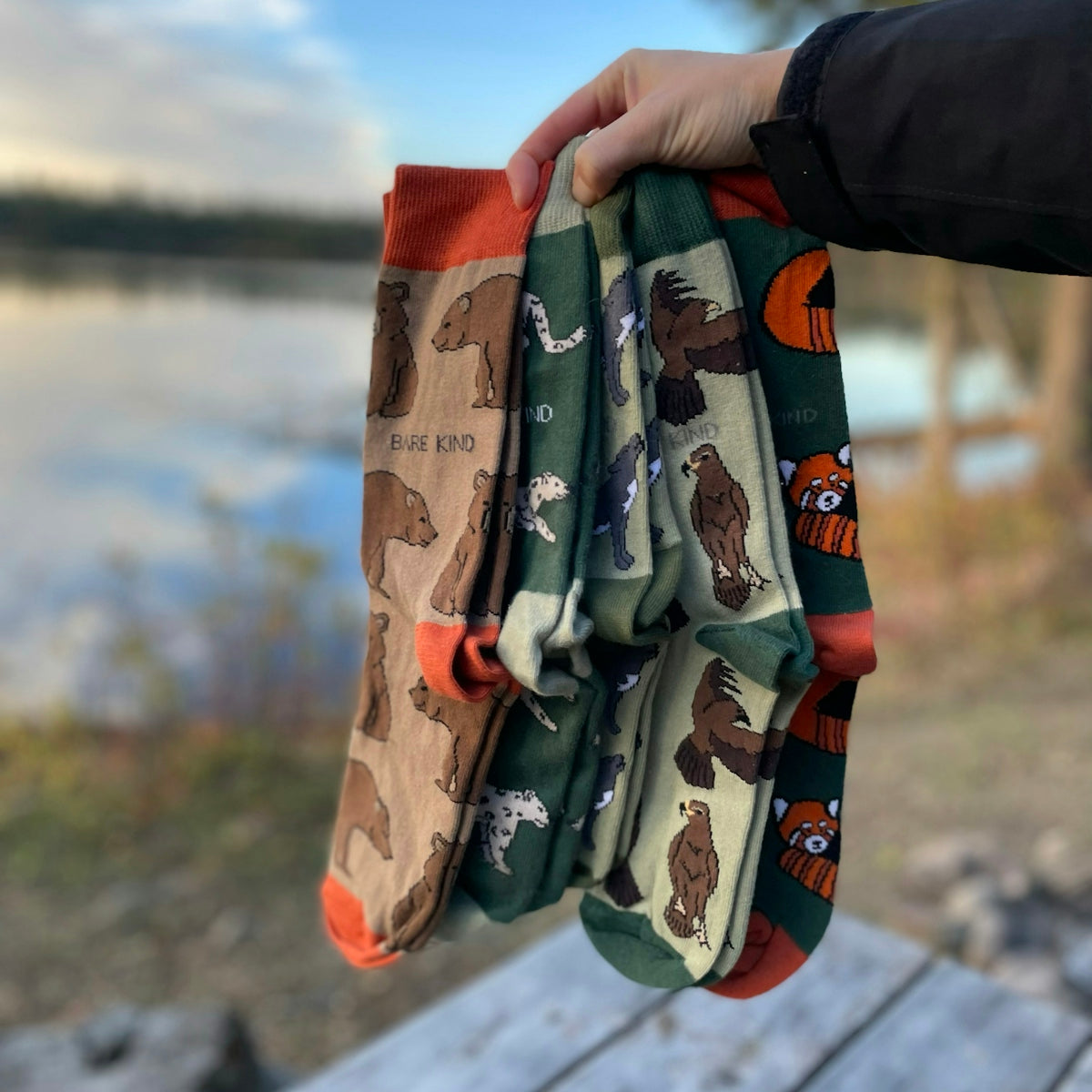 A person holding a pair of oven mitts