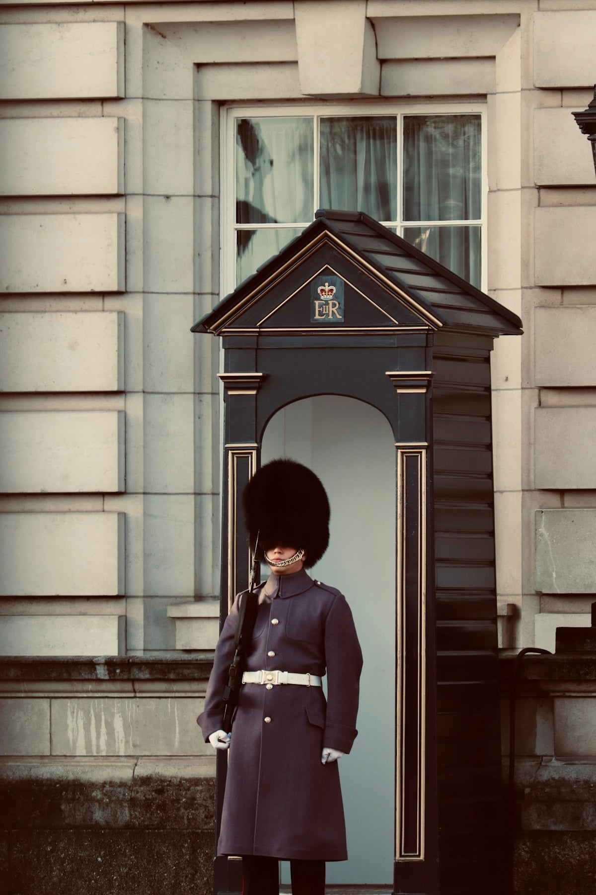 A buckingham palace guard stands at attention.