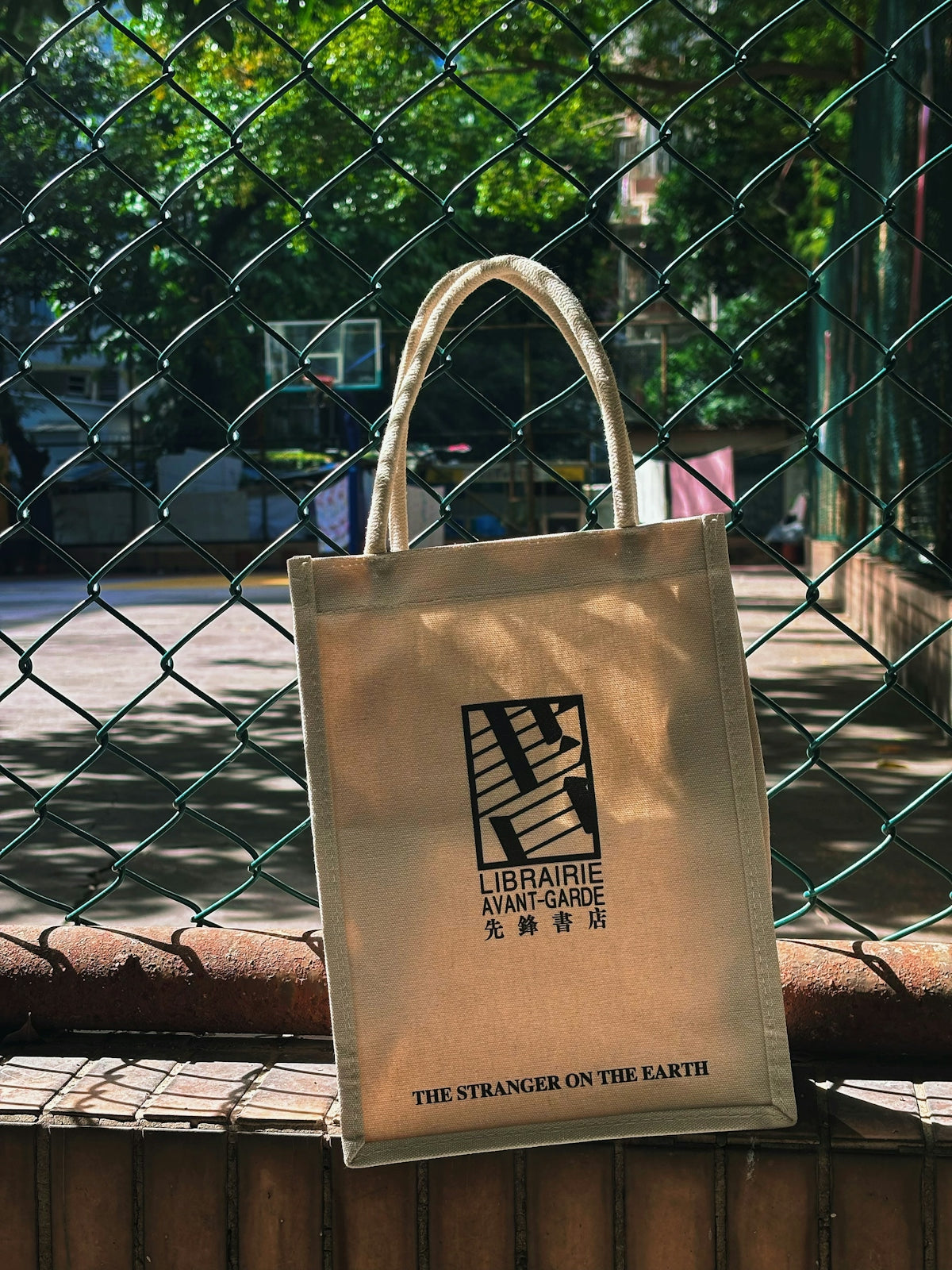 A canvas tote bag with a logo and text.
