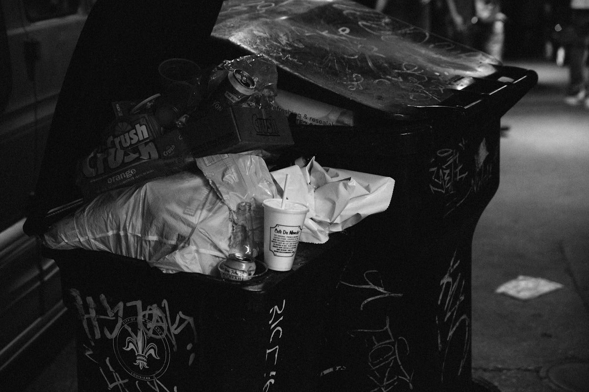 a black and white photo of a trash can