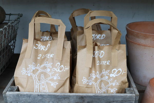 Bags of jord soil are for sale.