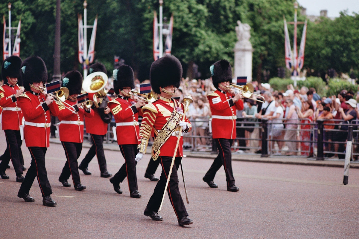 A british band is marching in a colorful parade.